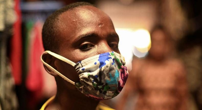 Eugene Amuri, a vendor at the Kimironko market wears a handmade kitenge cloth mask as he attempts to protect against the coronavirus disease (COVID-19), in Kigali, Rwanda March 17, 2020. (REUTERS/Maggie Andresen)