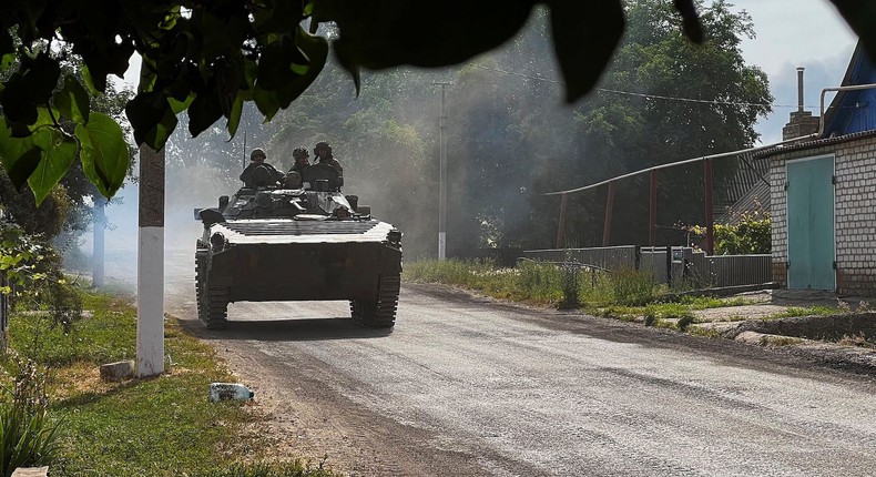 Ukrainian soldiers ride an armoured vehicle on the main road to Lysychansk in Ukraines eastern region of Donbas on June 26, 2022.