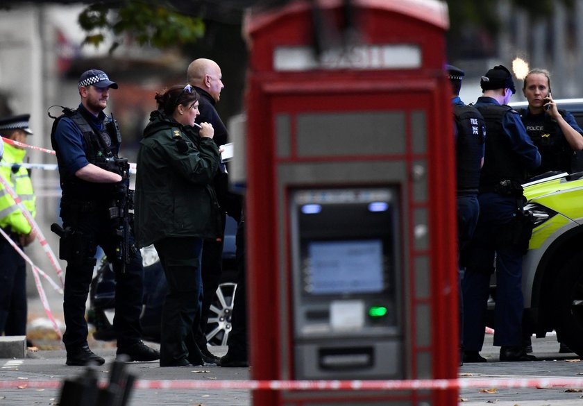 Emergency services personnel wheel a woman in a wheelchair to a nearby ambulance near the Natural Hi