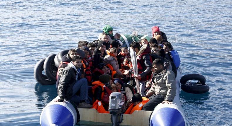 Refugees and migrants are seen on a dinghy as they approach the Ayios Efstratios Coast Guard vessel, during a rescue operation at open sea between the Turkish coast and the Greek island of Lesbos, February 8, 2016. REUTERS/Giorgos Moutafis