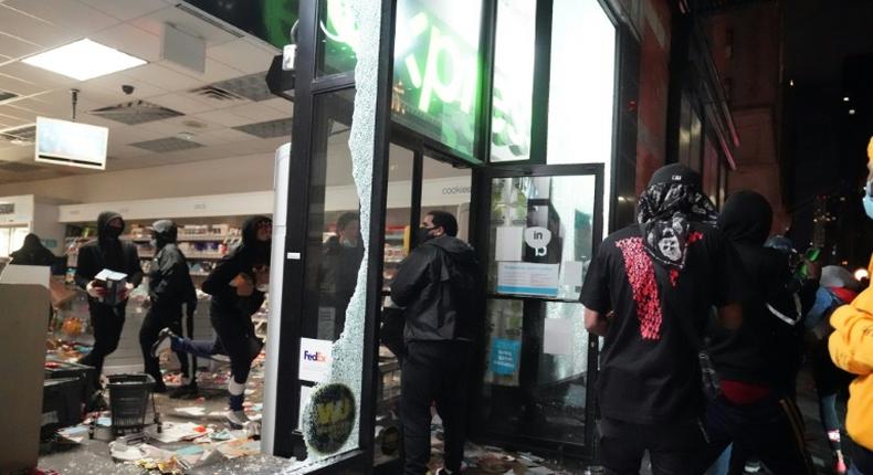 Looters hit stores in New York where the mayor has imposed an overnight curfew