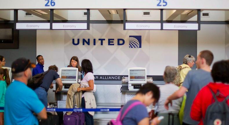 Travelers line up at a United Airlines check-in counter at Hartsfield–Jackson Atlanta International Airport.