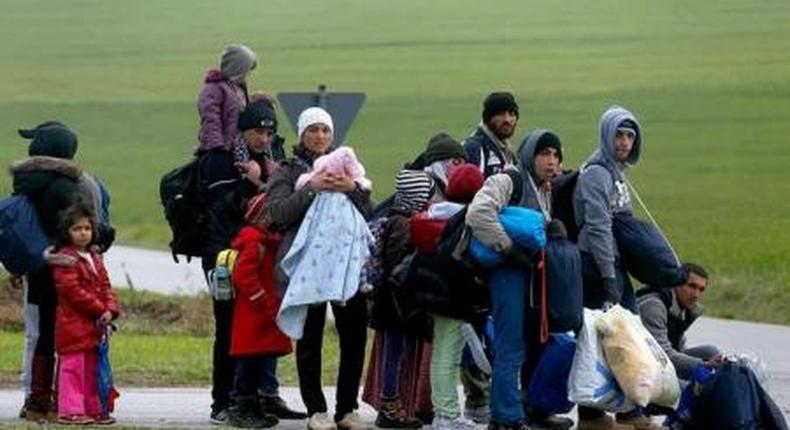 Migrants rest after crossing the Austrian-German border in Wegscheid near Passau, Germany, October 20, 2015.