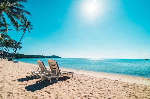 Beautiful tropical beach and sea with chair on blue sky for travel and vacation