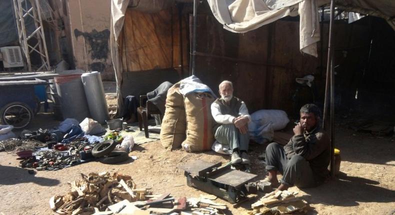 Men sell wood outside in the Syrian city of Deir Ezzor, parts of which were siezed by the Islamic State in 2014 after the group's lightning advance across large areas of Syria and neighbouring Iraq