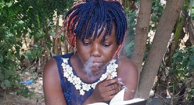 This lady is reading the Holy Bible while smoking at the same time