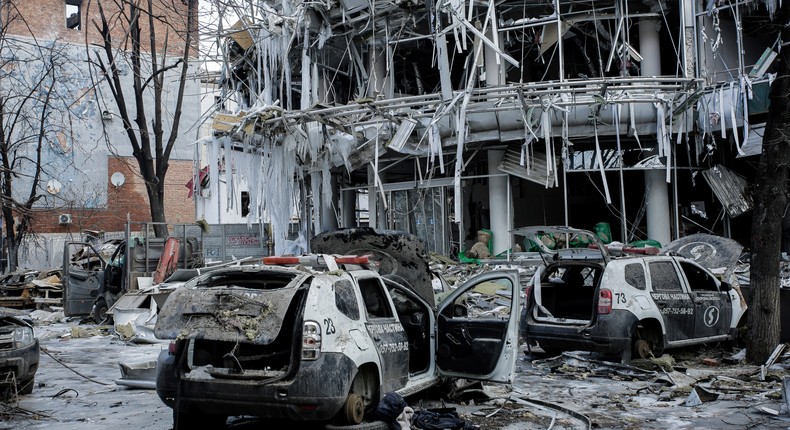 Damaged vehicles sit among debris and in Kharkiv city center in Ukraine, Wednesday, March 16, 2022.