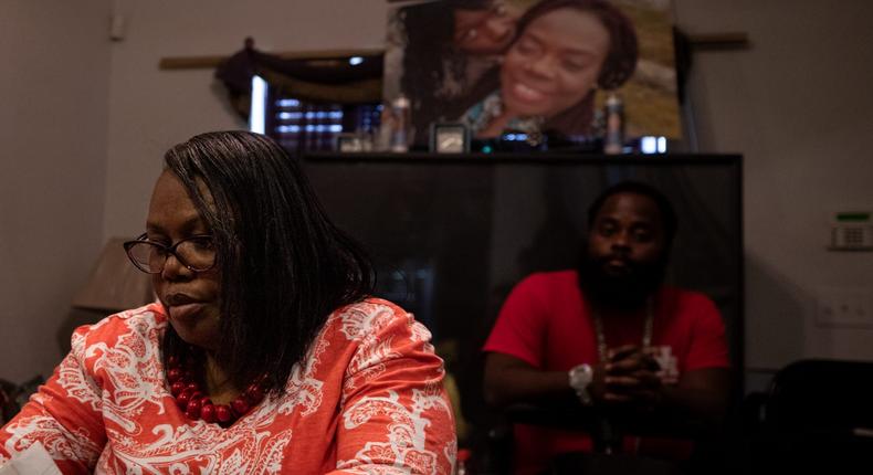 Joann McFadden with her daughter's  fianc, Guy Hemphill Jr., at her home in San Antonio, beneath a photo of Kenne McFadden, her late daughter.Kaylee Greenlee Beal for Insider