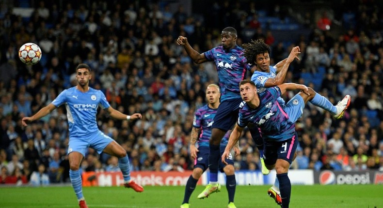 Tinged with sadness: Manchester City's Dutch defender Nathan Ake  jumps to head the ball home Creator: Oli SCARFF