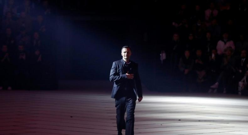 Artistic director for Dior Homme, Belgian fashion designer Kris Van Assche, acknowledges the public at the end of the men's Fashion Week for the Fall/Winter 2017/2018 collection in Paris on January 20, 2017