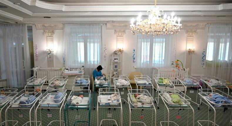 A nurse cares for newborn babies at Kiev's Venice hotel -- dozens born to surrogate mothers were stranded in Ukraine as their foreign parents were unable to collect them for weeks owing to coronavirus border closures