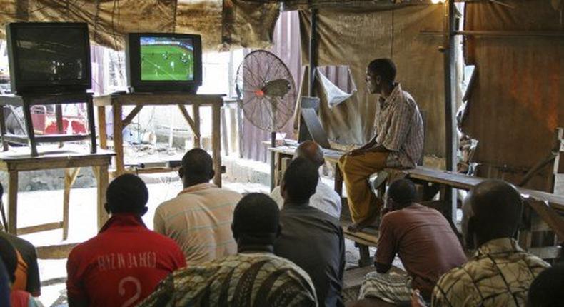 Football lovers watching a match at a typical local centres in Nigeria.