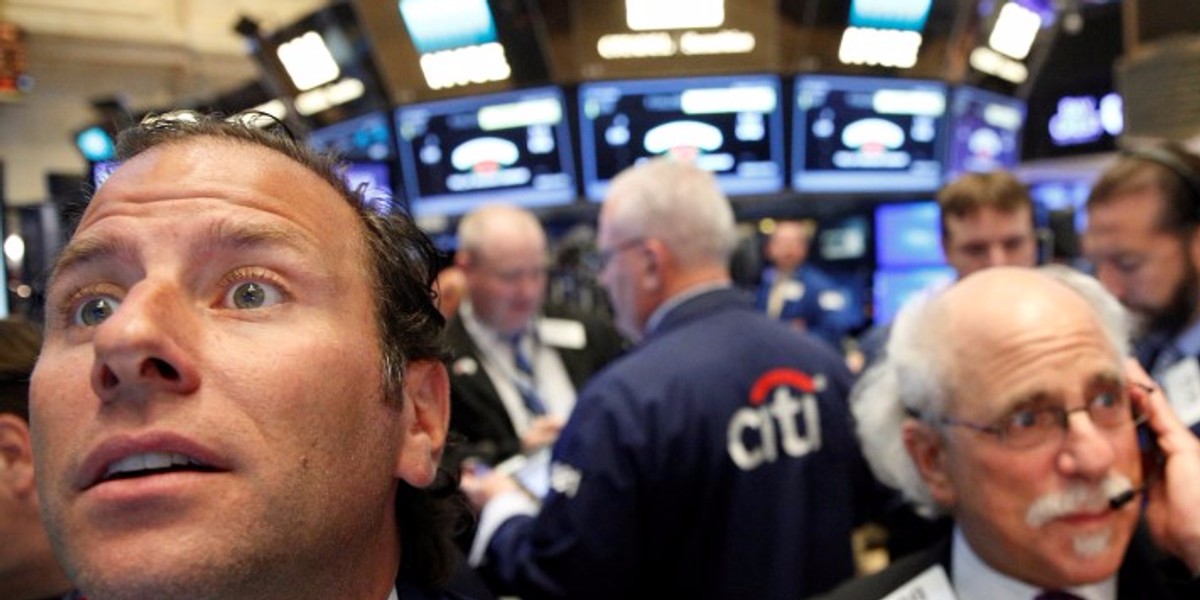 Traders work on the floor of the NYSE