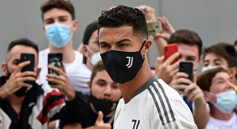 Juventus forward Cristiano Ronaldo is greeted by fans as he arrives for his medical examination at the Juventus medical center in Turin. Creator: MIGUEL MEDINA