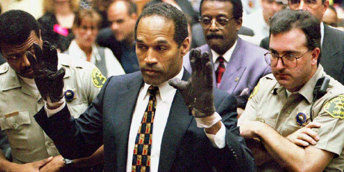 O.J. Simpson trying on the bloody gloves during his murder trial in 1995.