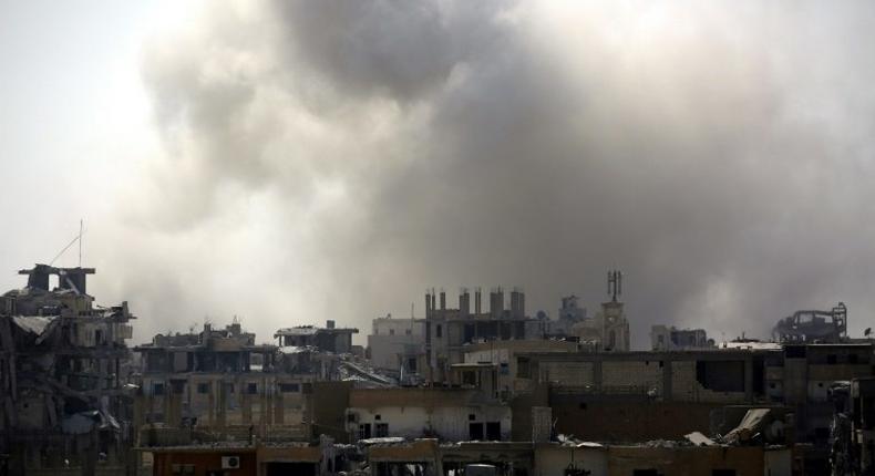 Smoke rises from building in Raqa's eastern al-Sanaa neighbourhood, on the edge of the old city, on August 13, 2017