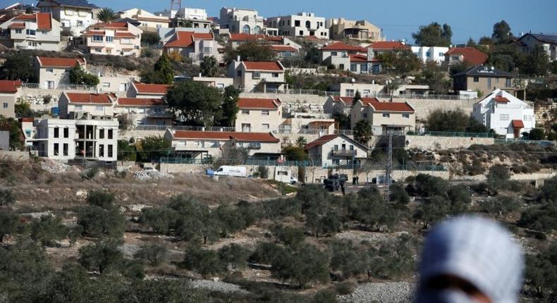 A Palestinian protestor in front of the Israeli settlement of Qadumim (Kedumim), near Nablus, in the occupied West Bank on December 9, 2016