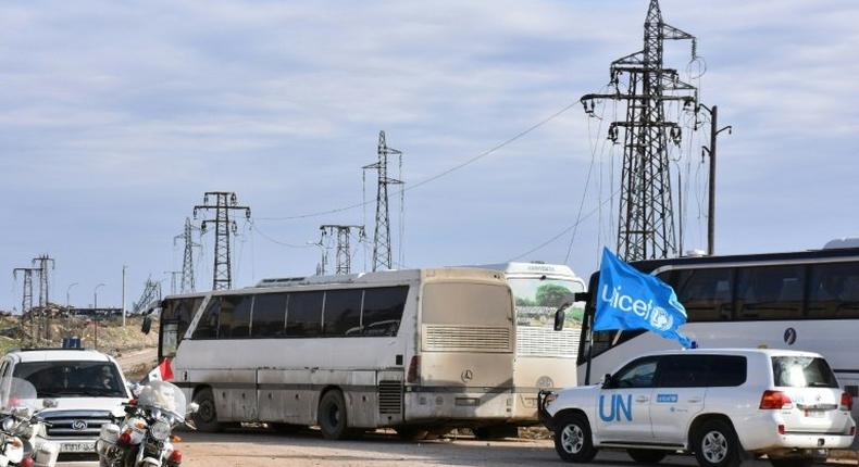 A vehicle from the United Nations drives through the Syrian government-controlled crossing of Ramoussa, on the southern outskirts of Aleppo, on December 18, 2016