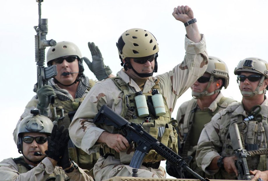 US Navy SEALs react in recognition of contributions of former SEALS after a demonstration of combat skills at the National Navy UDT-SEAL Museum in Fort Pierce, Florida November 12, 2011.