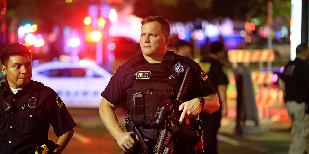 Dallas police stand watch near the scene where four Dallas police officers were shot and killed on July 7, 2016 in Dallas, Texas.