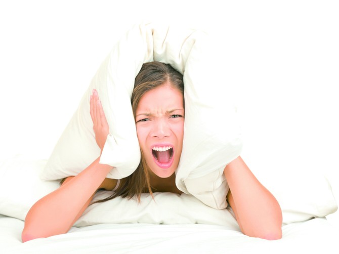 107957_stockphotobedwomancoveringearswithpillowbecauseofnoisefunnyimageisolatedonwhitebackgrounda