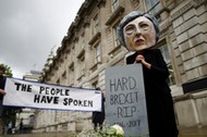 Protestor wearing a Theresa May mask is seen the day after Britain's election in London