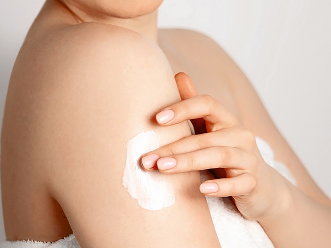 stock-photo-panoramic-beauty-banner-young-woman-in-towel-after-shower-applying-a-body-cream-skin-care-1932328778
