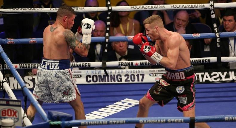 Britain's Terry Flanagan (L) measures Puerto Rico's Orlando Cruz (L) during their World Boxing Organisation lightweight title bout held at the Motorpoint Arena, November 26, 2016