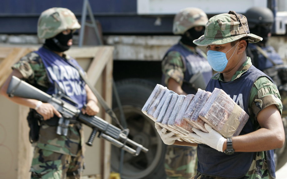 A marine carries packs of cocaine at a naval base in Manzanillo, Colima state, November 5, 2007.