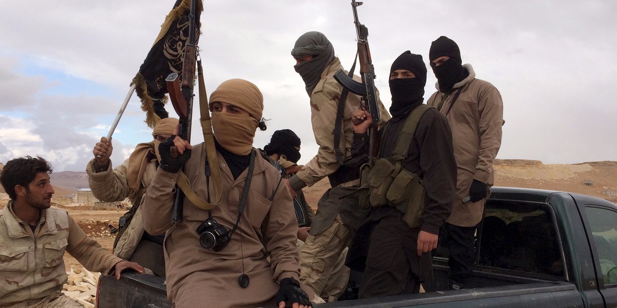 Al Qaeda-linked Nusra Front fighters carry their weapons on the back of a pick-up truck during the release of Lebanese soldiers and policemen in Arsal, eastern Bekaa Valley, Lebanon, December 1, 2015.