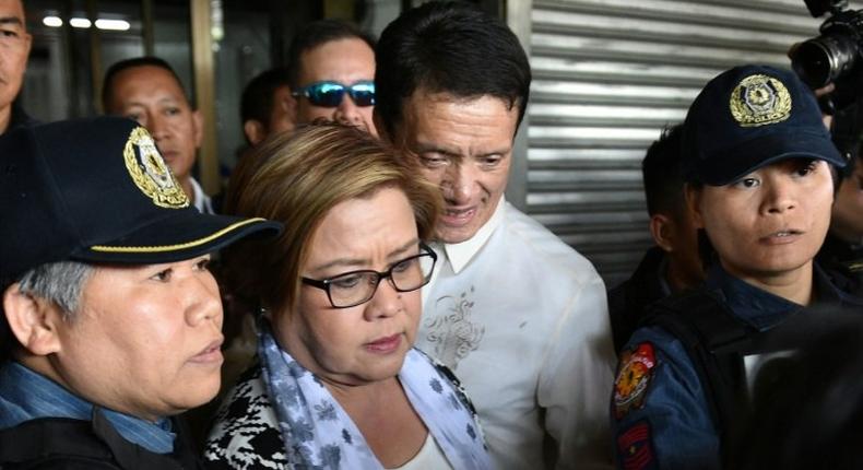 Philippine Senator Leila De Lima (C), a top critic of President Rodrigo Duterte, is escorted by police officers and her lawyer Alex Padilla (R) after her arrest at the Senate in Manila on February 24, 2017