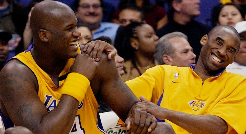 FILE - In this April 15, 2003, file photo, Los Angeles Lakers Shaquille O'Neal, left, and Kobe Bryant share a laugh on the bench while their teammate take on the Denver Nuggets during the fourth quarter at Staples Center in Los Angeles. Bryant, the 18-time NBA All-Star who won five championships and became one of the greatest basketball players of his generation during a 20-year career with the Los Angeles Lakers, died in a helicopter crash Sunday, Jan. 26, 2020. (AP Photo/Kevork Djansezian, File)