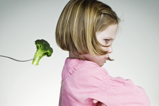 Young Girl Refusing To Eat Her Greens