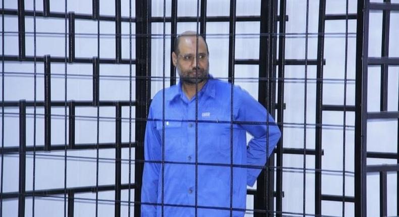 Saif al-Islam Gaddafi, son of late Libyan leader Muammar Gaddafi, attends a hearing behind bars in a courtroom in Zintan, June 22, 2014 . 