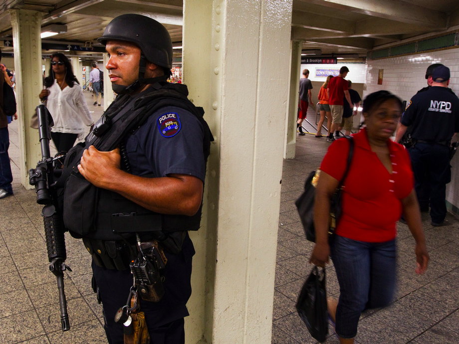 A New York Police Department officer stands at an entrance to the subway.