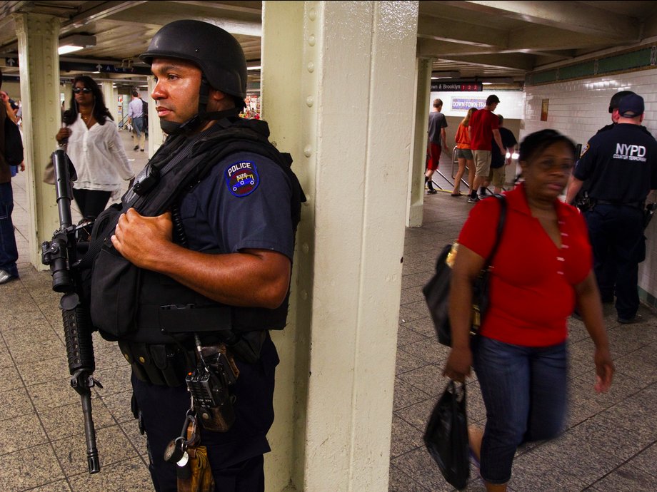 A New York Police Department officer stands at an entrance to the subway.