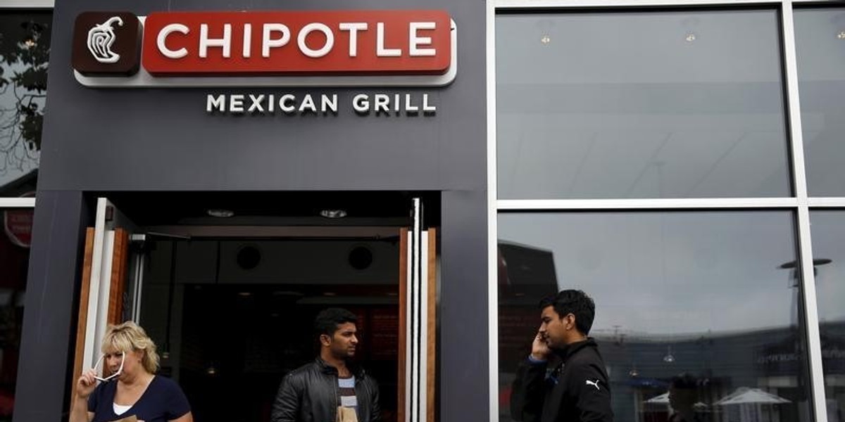 People carry bags as they leave a Chipotle Mexican Grill restaurant in San Francisco, California