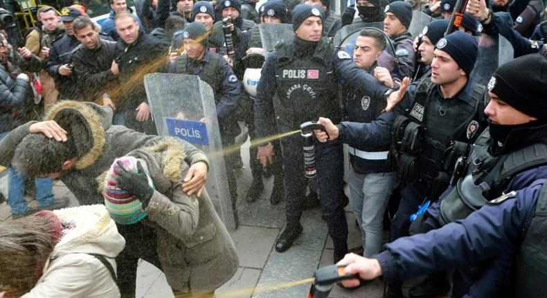 Turkish policemen spray tear gas at protestors who tried to demonstrate in Ankara on November 30, 2016, after 12 people, most of them young schoolgirls, were killed in a fire that ravaged a dormitory