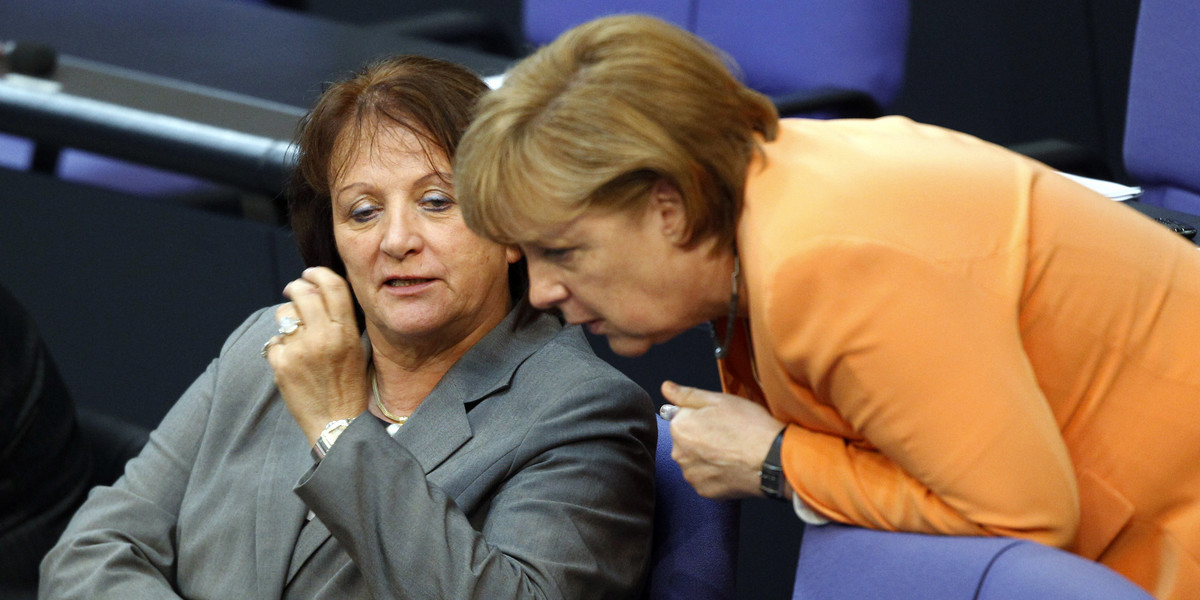 German Chancellor Angela Merkel, right, and Justice Minister Sabine Leutheusser-Schnarrenberger talk during a debate about a proposed resolution on circumcision in Berlin, July 19, 2012.