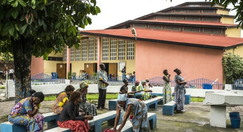 People pray outside the Saint Raphael Parish in Kinshasa, on December 18, 2016