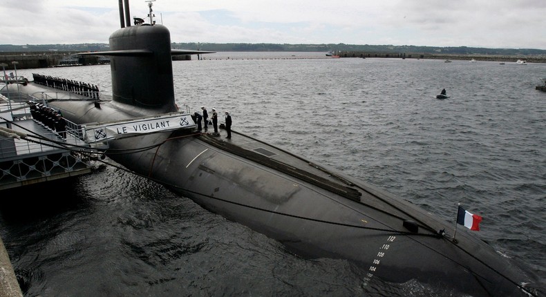 French Marine officers wait atop Le Vigilant nuclear submarine at L'Ile Longue military base, near Brest, Brittany.
