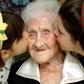 The World's oldest woman, Jeanne Calment, 120 years old, is kissed by two young girls during a speci