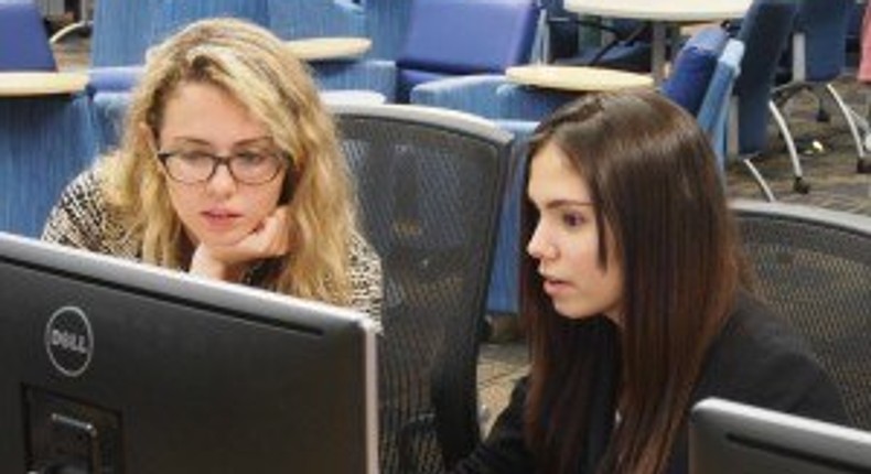 Emily Reid with a student at Girls Who Code