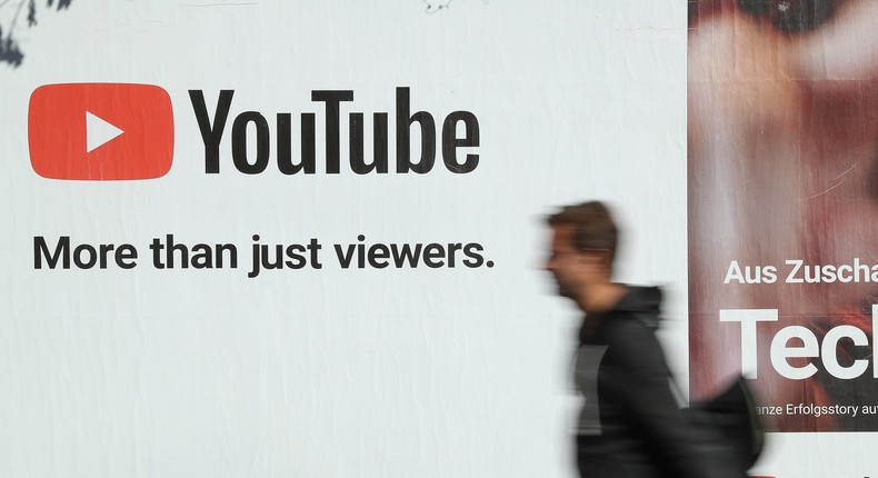 A man walks past a billboard advertisement for YouTube on October 5, 2018 in Berlin, Germany.