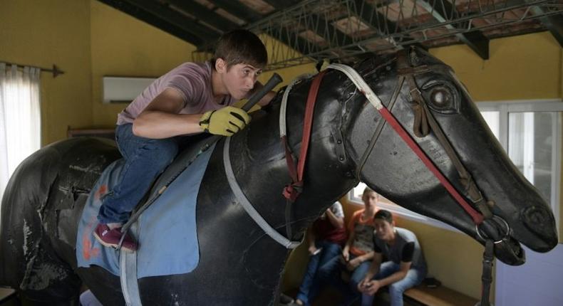 Apprentice Lucas Berticelli rides a mechanical racehorse at the San Isidro Jockey Club school on the outskirts of Buenos Aires