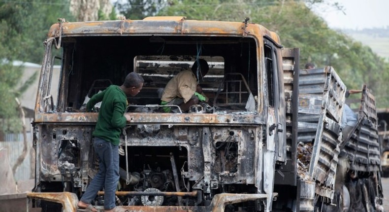 Children explore the remains of a cargo truck in Sebeta, central Ethiopia on October 13, 2016 after protesters took to the street to vandalise property thought to belong to the government