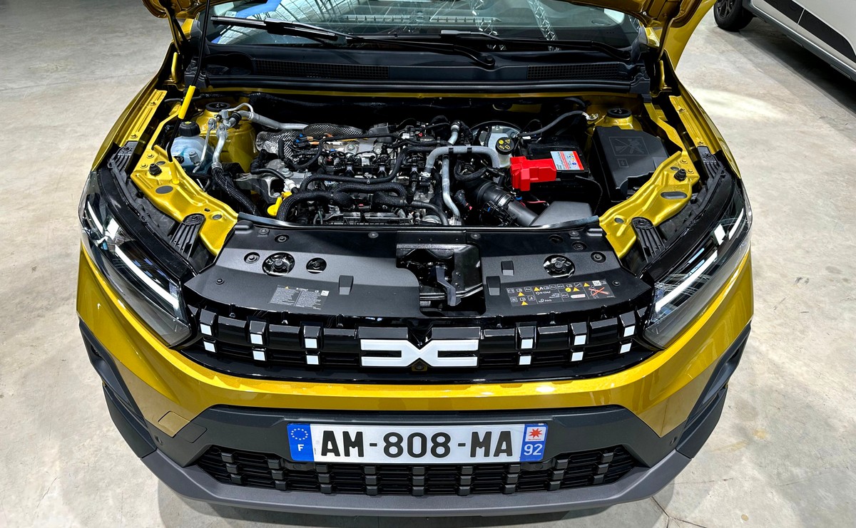 Nowa Dacia Sandero Stepway w kolorze złotym z otwartą maską, prezentująca nowy silnik 1.2 z LPG oraz zmodernizowany grill z białymi elementami i reflektory LED