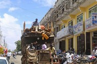 A truck drives through Bakara market in Mogadishu October 5, 2013. Street lamps now brighten some of Mogadishu's battle-scarred roads and couples hold hands at the seaside next to bombed-out beachfront buildings, a scene that would have been unthinkable w