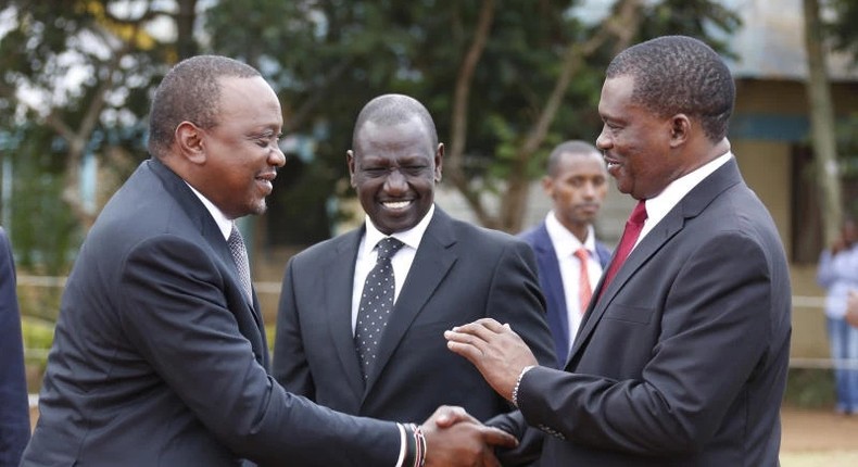 President Uhuru Kenyatta consoles National assembly speaker Justin Muturi during the burial service of the mother of National Assembly Speaker Justin Muturi in Embu County, looking on is DP WIlliam Ruto.