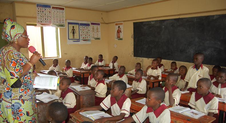 Ekiti State ex-governor's wife, Erelu Bisi Fayemi, teaching Primary 4 pupils of the SUBEB Model Nursery and Primary School, Efon-Alaye.